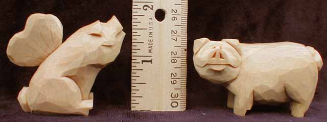 two pigs with ruler